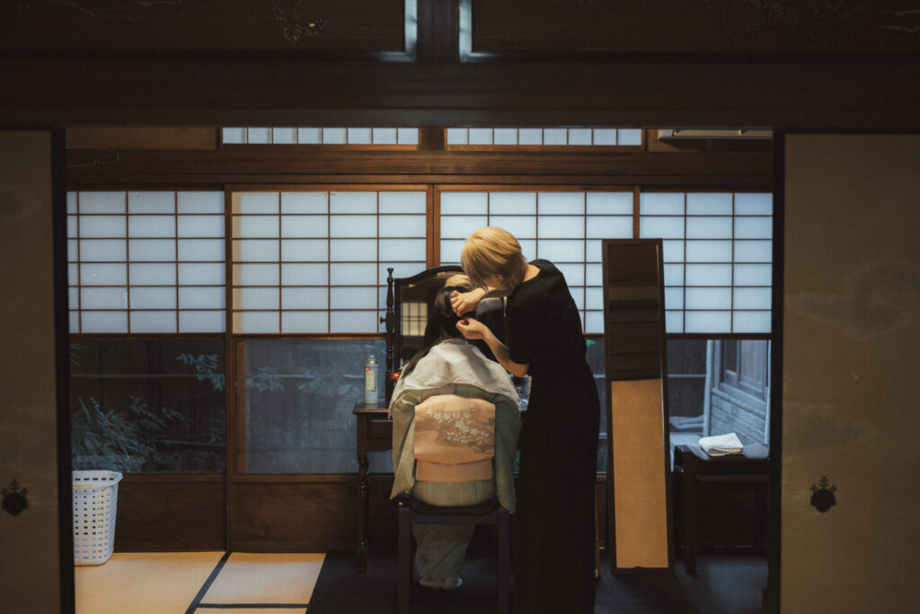Professional hairstyling for a kimono guest inside a traditional Kyoto machiya